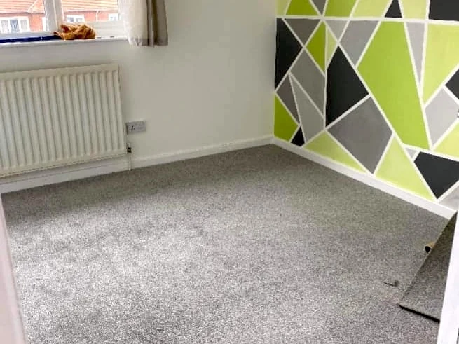 bedroom-carpet-grey-geometric-wallpaper-newcastle-foxglove-flooring Grey bedroom carpet against a geometric feature wall, Newcastle