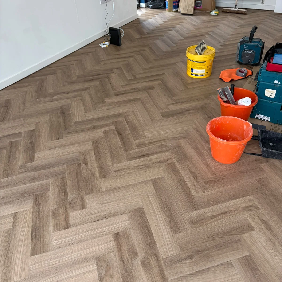 lvt-fitting-in-progress-newcastle-foxglove-flooring Herringbone pattern taking shape mid-fit, Newcastle
